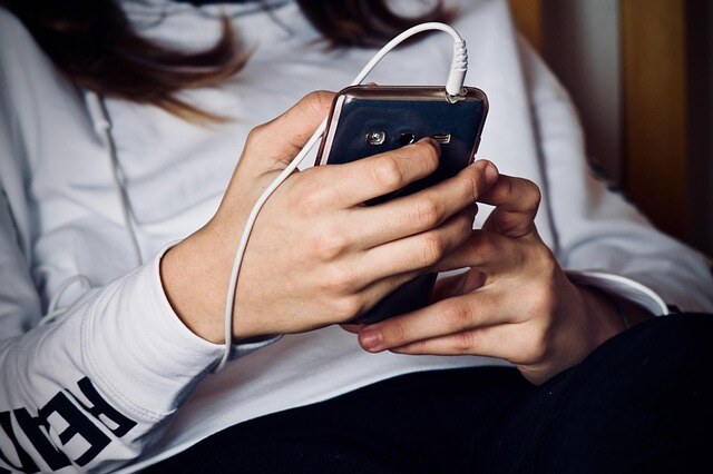 woman's hands holding a mobile phone